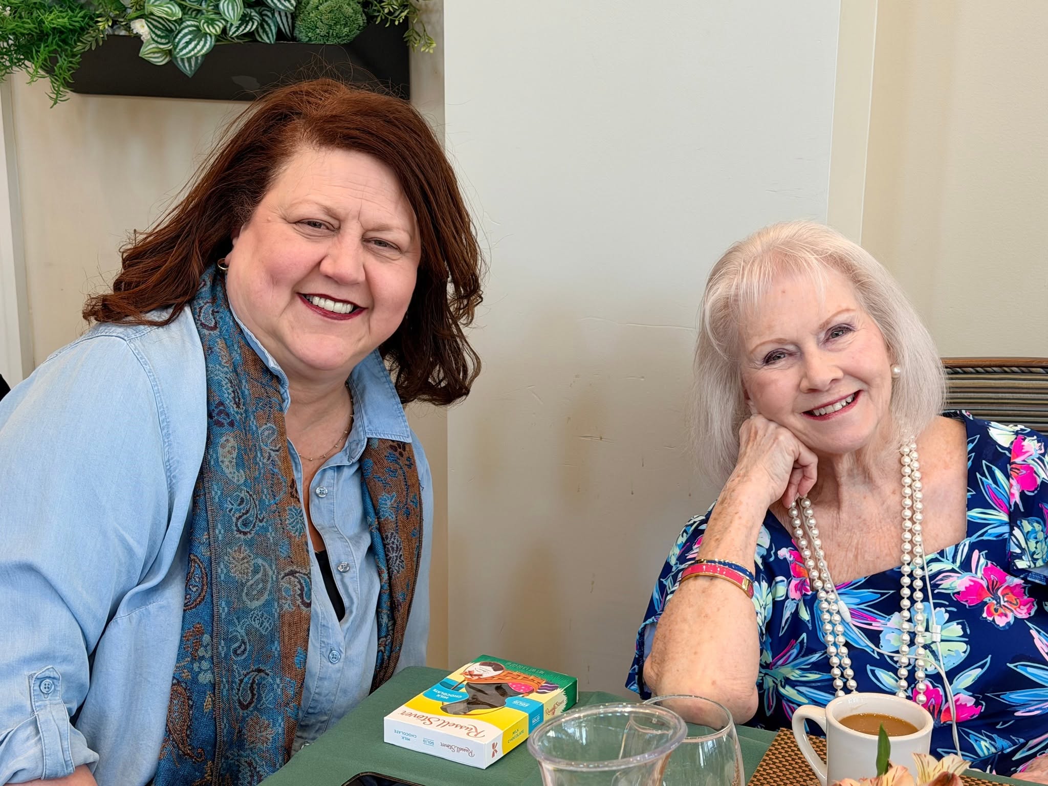 A resident and team member sharing coffee