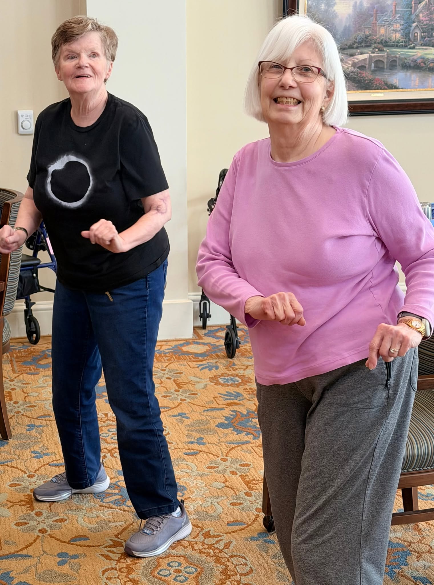 Two residents dancing during an afternoon fitness class
