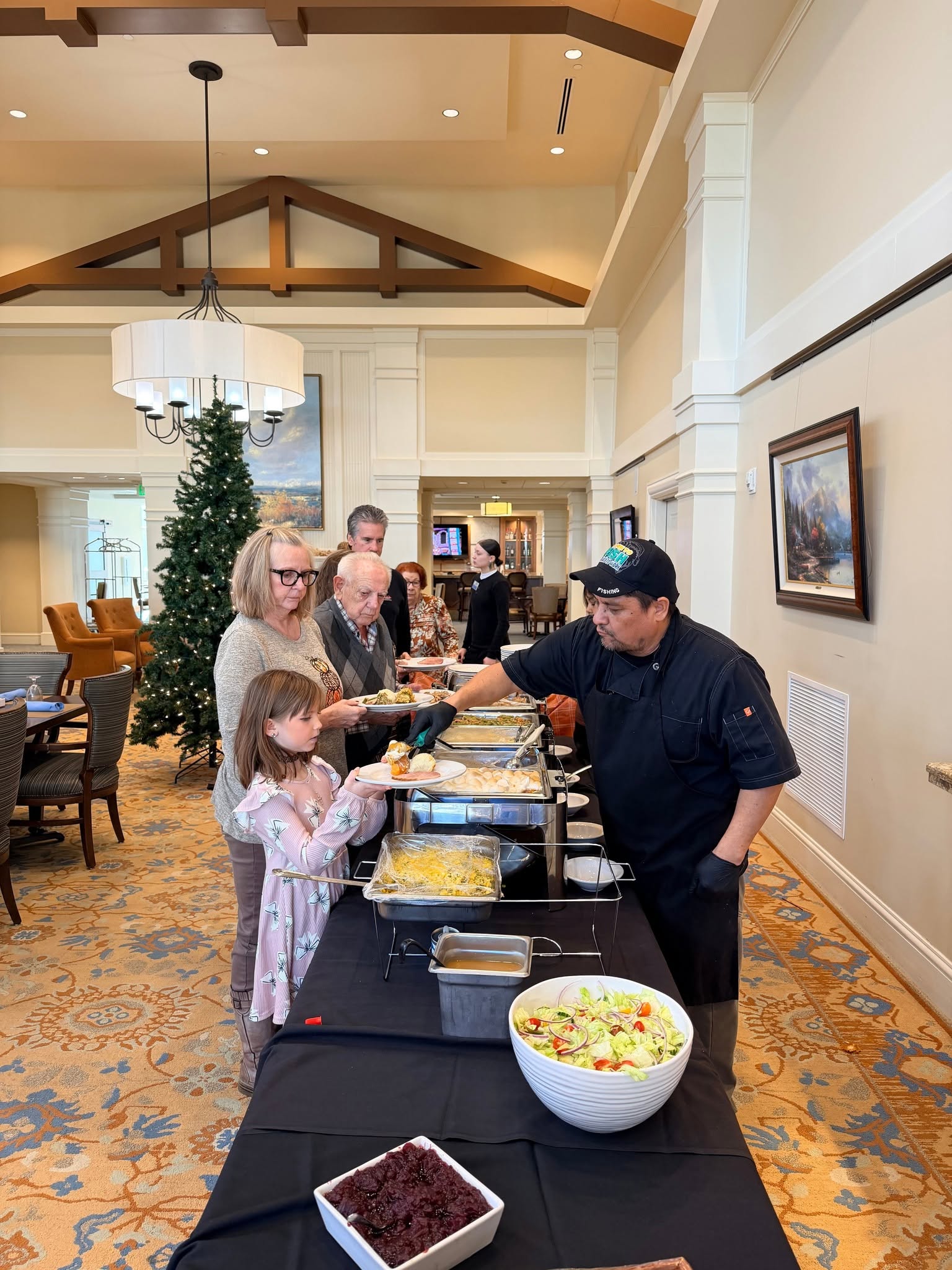 Chef serving a holiday meal to residents and family