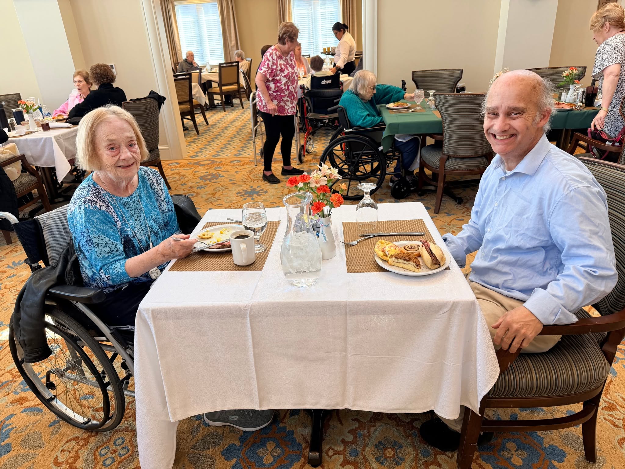 Two residents sharing breakfast in the dining room